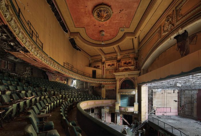 Colour auditorium photo from the first balcony looking across to the opposite side boxes and up to the ceiling. 