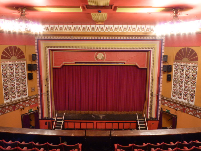 View from the back of the balcony across the stalls to the stage at Tameside Hippodrome.