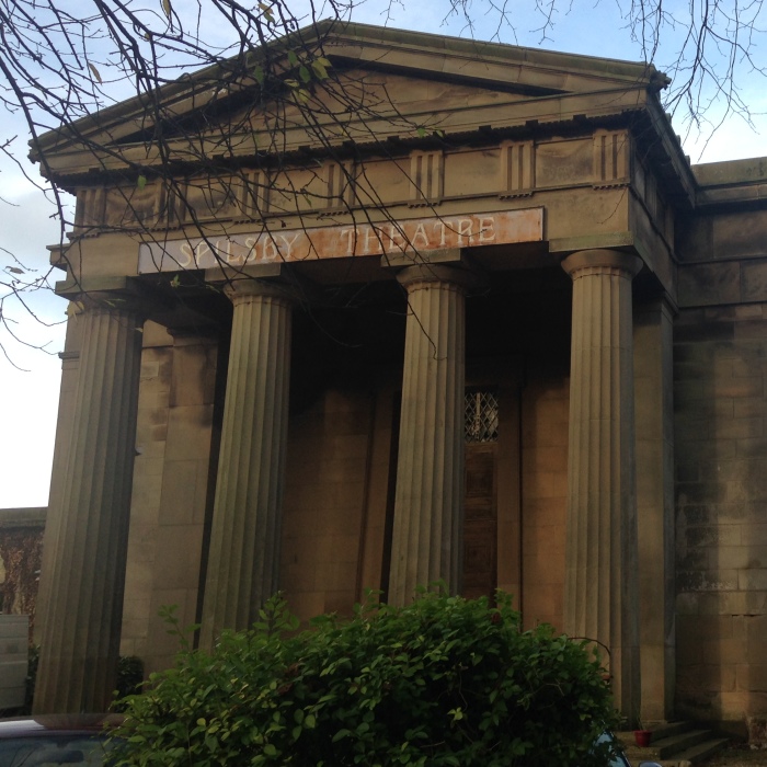 The exterior of Spilsby Theatre set in tree-lined grounds.