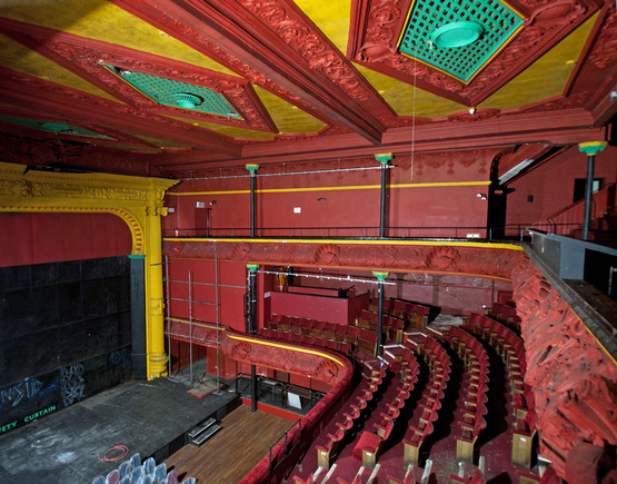 Red painted auditorium of Hulme Hippodrome