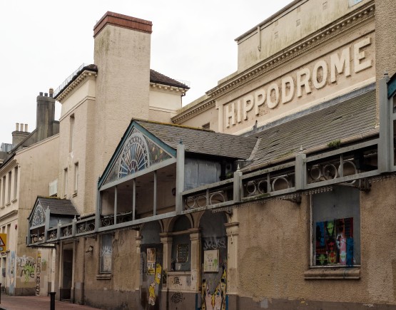 Brighton Hippodrome exterior, with its coloured glass awning and external walls covered with grafitti including Bart Simpson