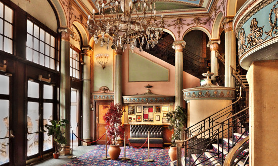 The opulent entrance foyer of Streatham Hill Theatre with remnants of theatre use, including a box office