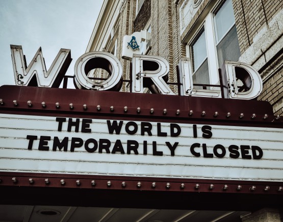 An image of a sign at The World theatre saying 'The World is temporarily closed'.