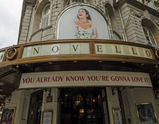 Signage for Mamma Mia show above the entrance of the Novello theatre