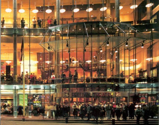 Exterior of Edinburgh Festival Theatre, a modern glass front building, with crowds outside
