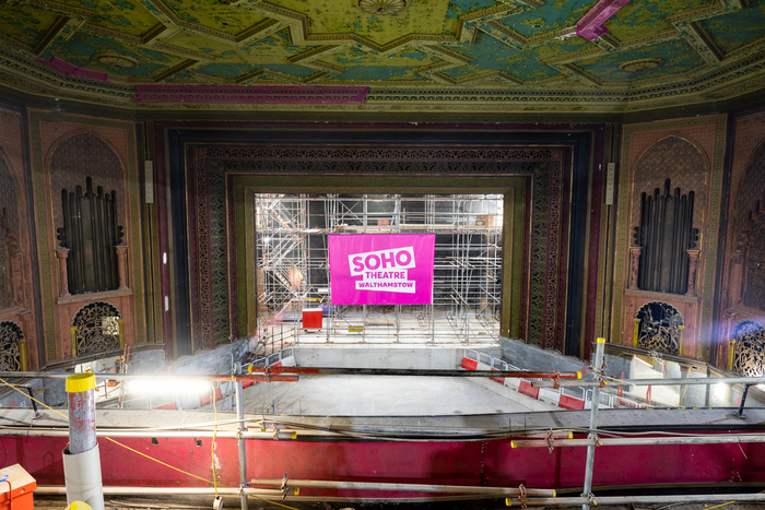 Walthamstow Granada, a historic theatre auditorium undergoing restoration works with pink sign on stage saying Soho Theatre Walthamstow