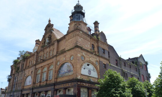 Corner photo of Plymouth Palace with its art nouveau armada tiles adorning the facade. 