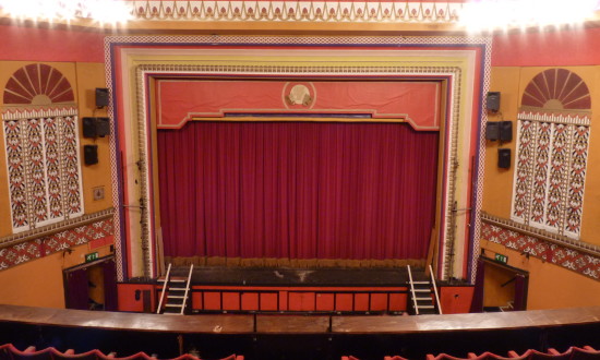View from the back of the balcony across the stalls to the stage at Tameside Hippodrome.