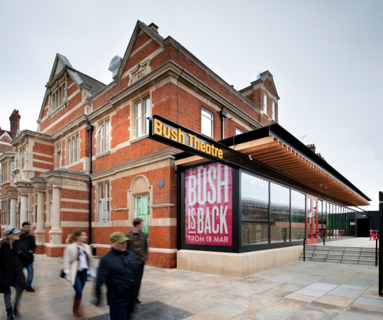 Exterior of Bush Theatre from a busy street with signage.