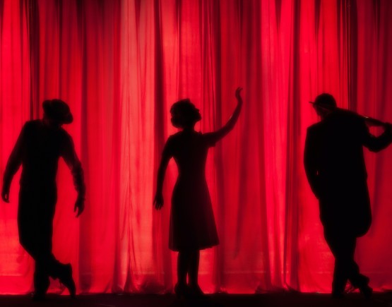 Shadow people and stage curtain.