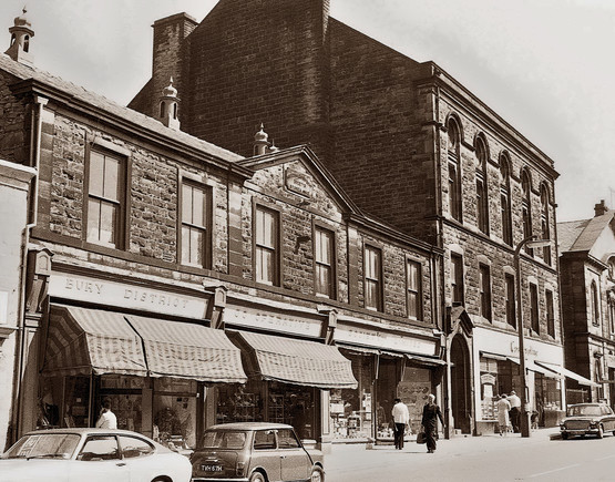 Sepia streetscape postcard of Ramsbottom Co-op Hall