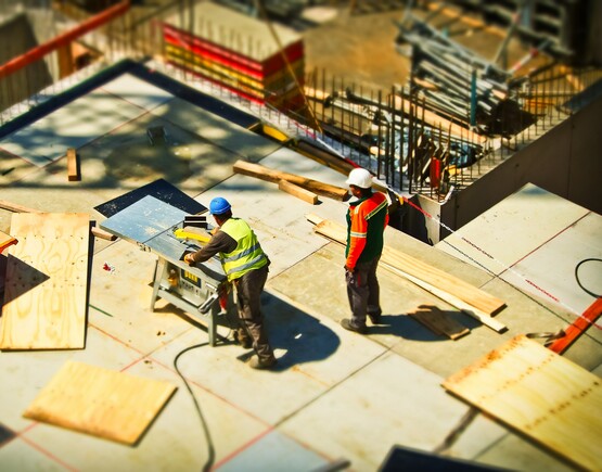 Two men on a construction site. Photo by Pixabay