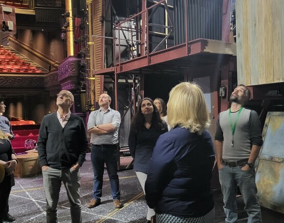 Group of people on backstage tour of a theater