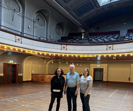 Two women and a man stood in Leith Theatre auditorium.