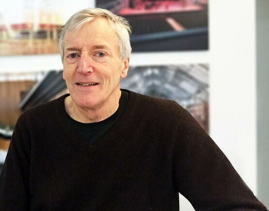 Axel Burrough, a white man with white hair wearing a black jumper.